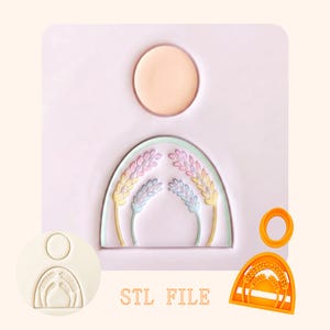 May include: A light purple rectangular mould featuring a circular indentation above an arched design containing four wheat stalks. To the side, an orange plastic cutter set includes a circular piece and an arched piece with wheat stalk cutouts.
