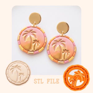 May include: A pair of round earrings with a tropical theme. The earrings feature a gold palm tree design on a pink and orange background, with a gold disc at the top. The earrings are accompanied by an STL file.