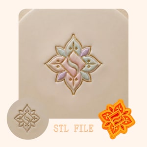 May include: A floral design with pastel colors and gold trim is featured on a square surface. The image includes a circular stamp and a 3D printed cutter of the same design. The text "STL FILE" is also present.