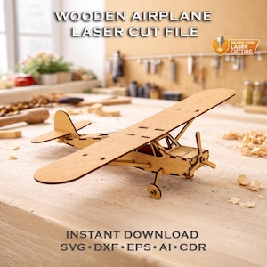 May include: A wooden airplane model, laser cut from light brown wood, sits on a wooden surface. The model has a propeller, wings, and tail, with the text "WOODEN AIRPLANE LASER CUT FILE" and "INSTANT DOWNLOAD" visible.
