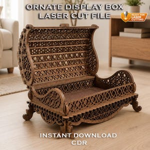 May include: A brown wooden display box with an open lid and intricate laser-cut lattice patterns on the sides and back. The structure features curved edges, a flat base, and four small feet. Text reads: ORNATE DISPLAY BOX LASER CUT FILE.