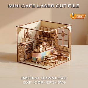 May include: A miniature wooden cafe model, laser cut with intricate details. The model includes tables, chairs, a counter with rainbow accents, and shelves with cups and food items. Text on the image reads "MINI CAFE LASER CUT FILE" and "INSTANT DOWNLOAD".