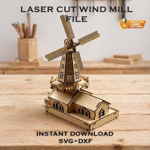 May include: A laser-cut wooden windmill model with a detailed design. The windmill features a tower with windows, a rotating fan, and a base with a house-like structure. Text on the image reads "LASER CUT WIND MILL FILE" and "INSTANT DOWNLOAD SVG • DXF."