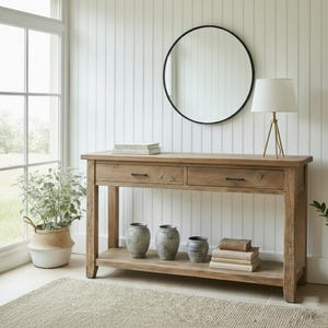 May include: A white ceramic mug with a black handle and the text "But first, coffee" in a handwritten style. The mug is on a white surface. The mug is likely for hot beverages.