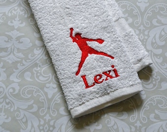 May include: White towel with red embroidered softball player and the name "Lexi".