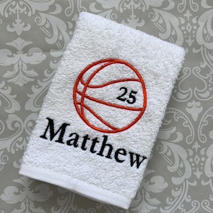 May include: White towel with orange and black embroidery of a basketball with the number 25 and the name Matthew.