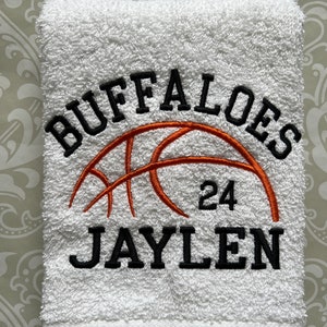 May include: White towel with black embroidered text "Buffaloes" and "Jaylen" with a basketball graphic and the number "24" in orange.