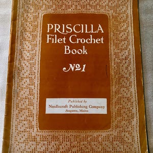 May include: A vintage "Priscilla Filet Crochet Book No. 1" with a brown cover and white lace-like border. The book's title is in white, with the publisher's information at the bottom. The book is a guide for filet crochet.