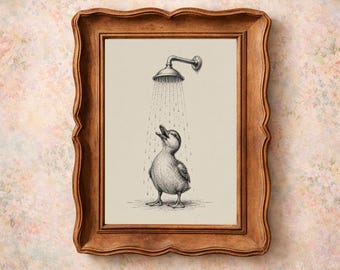 May include: A framed print featuring a whimsical illustration of a duckling enjoying a shower. The artwork is in black and white, with the duckling standing under a shower head. The frame is a warm brown color, adding a vintage touch to the piece.