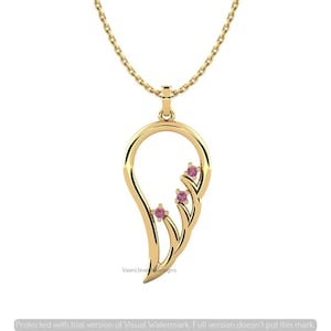 May include: A gold pendant necklace featuring a stylized wing shape with three small, round, pink gemstones set along the inner curve. The pendant hangs from a delicate gold chain, creating a polished and refined piece of jewelry.