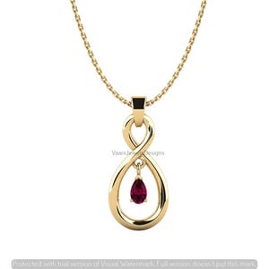 May include: A gold necklace featuring an infinity-shaped pendant with a smooth, polished finish. A small, deep red, pear-shaped gemstone hangs from the centre of the lower loop of the infinity symbol. The pendant is suspended from a delicate gold chain.