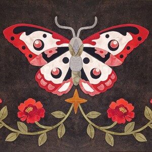 May include: A red and white butterfly with black markings is centered on a dark brown background.  The butterfly is surrounded by four red flowers with green stems and leaves.