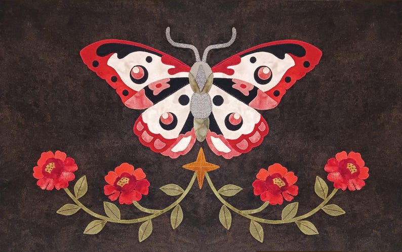 May include: A red and white butterfly with black markings is centered on a dark brown background.  The butterfly is surrounded by four red flowers with green stems and leaves.