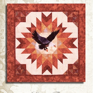 Op de afbeelding: Een quiltpatroon met een rood, oranje en wit stervormig ontwerp met een adelaar die in het midden vliegt. Het patroon is getiteld "A Blaze of Glory" en is gemarkeerd met "CT 230". De quilt is ongeveer 48 inch bij 48 inch.