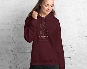 May include: A maroon hooded sweatshirt featuring a white line art illustration of a dog centered on the chest. Below the dog, the text reads DOG MUM CLUB in white capital letters, followed by the smaller text walks + coffee + chill.