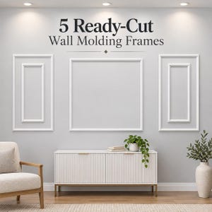 May include: A set of 5 ready-cut white wall molding frames installed on a light gray wall. The text 5 Ready-Cut Wall Molding Frames is displayed above the frames. The arrangement includes two vertical rectangular frames and one large square frame.