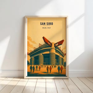 May include: A framed poster featuring a stylized illustration of the San Siro stadium in Milan, Italy. The artwork displays the stadium's distinctive cylindrical towers and red roof structures against a warm, golden-yellow sky with a crowd of people.