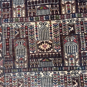 May include: A woven rug featuring a complex geometric pattern with a dark brown background. The design includes repeating architectural motifs, stylized floral elements, and vertical columns in shades of cream, red, blue, and green.