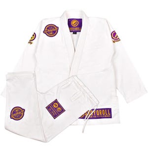 May include: White Jiu-Jitsu uniform with purple and gold embroidered patches. The uniform includes a jacket and pants. The jacket has a V-neck and the pants have a drawstring. The patches feature the text "Shoyoroll" and "Ju Jitsu".