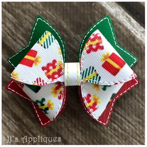 May include: A white, red, and green Christmas-themed bow with a white center. The bow is made of fabric with a pattern of presents and Christmas trees. The bow is edged with white stitching.