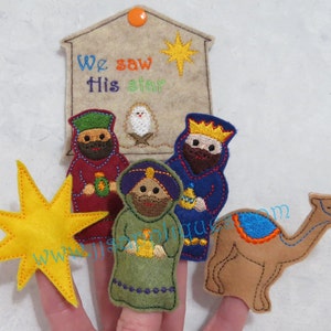 May include: A felt finger puppet set featuring the three wise men, a camel, and a yellow star. The puppets are designed for children to use during Christmas storytelling. The set includes a felt sign that reads "We saw His star".