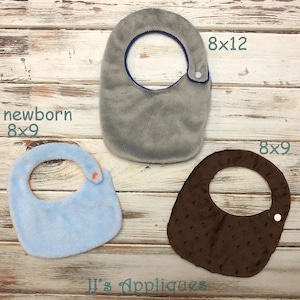 May include: Three baby bibs in different sizes and colours. The bibs are made of soft, plush fabric. The bibs are 8x9 inches, 8x12 inches, and newborn size. The bibs are perfect for keeping baby's clothes clean.