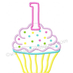 May include: A pink and yellow cupcake with a pink candle shaped like the number one on top. The cupcake is decorated with white frosting and colorful sprinkles.