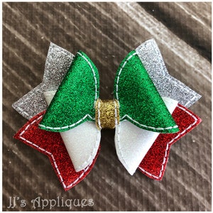 May include: A green, white, and red glitter bow with a gold center. The bow is made of felt and has a stitched edge.