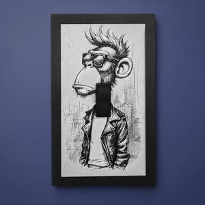 May include: A rectangular light switch cover featuring a black and white sketch of a monkey wearing sunglasses and a leather jacket. The artwork is framed by a solid black border and includes a central black rocker switch toggle mechanism.