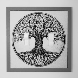 May include: A square double light switch cover plate featuring a circular black and white illustration of a tree with intricate branches, swirling leaves, and exposed roots. The plate has a gray border and two white vertical toggle switches.