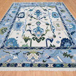 Detailed view of the navy green white rug geometric border featuring sage and royal blue accents.