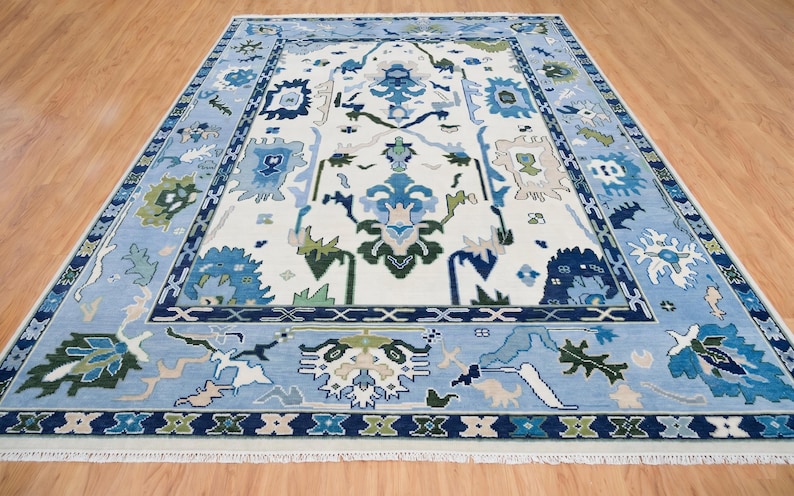 Detailed view of the navy green white rug geometric border featuring sage and royal blue accents.