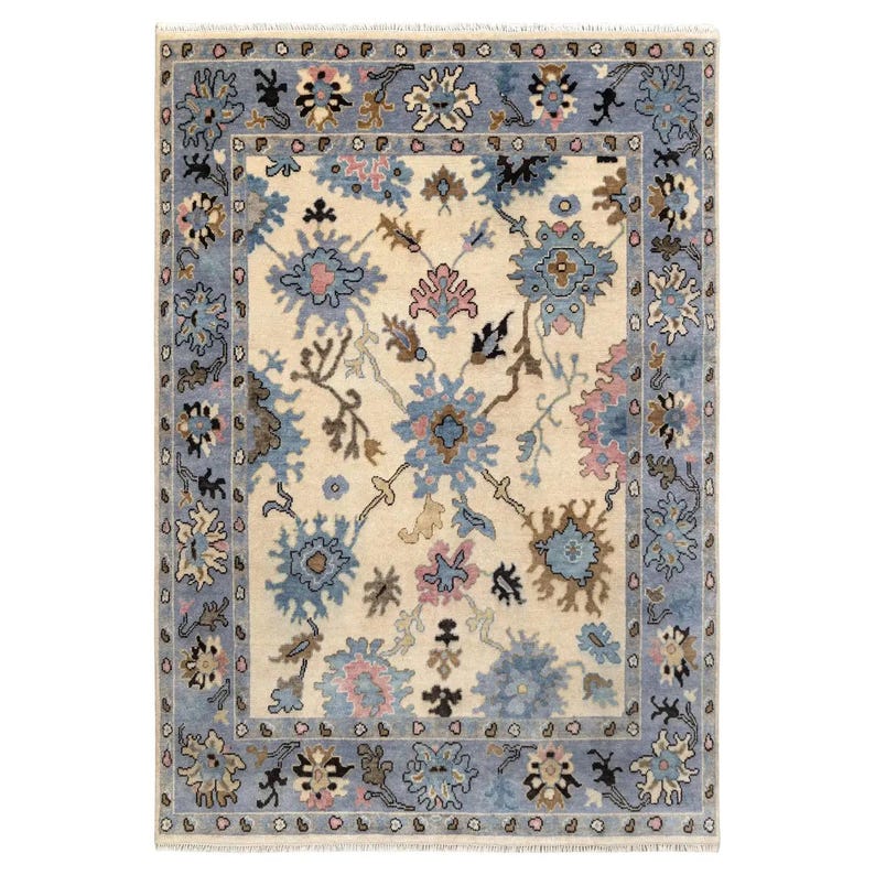 High-detail view of the soft rose and taupe stylized palmettes and lotuses, displaying exquisite handcrafted rugs artistry.