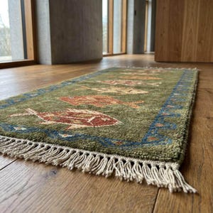 Bright room scene demonstrating how this olive green runner functions beautifully as a rich livingroom rug instead of a heavy southwestern rug.