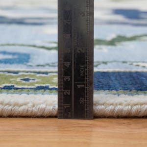 The rugs for living room styled in a bright, modern interior to show its grand scale and airy feel.