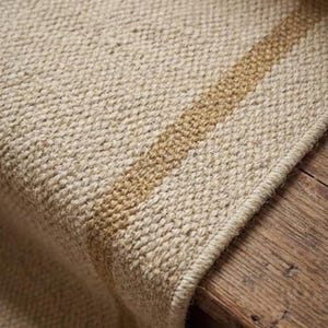 Wide perspective capturing the striking minimal cream and tan contrast, establishing this custom size runner as a premium handcrafted Wollteppich alternative to a mass-produced pottery barn franklin rug.