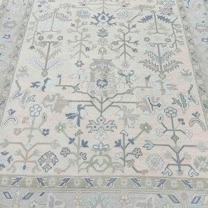 Overhead complete view of the oushak rugs displaying the full symmetry of the sophisticated floral vine borders.