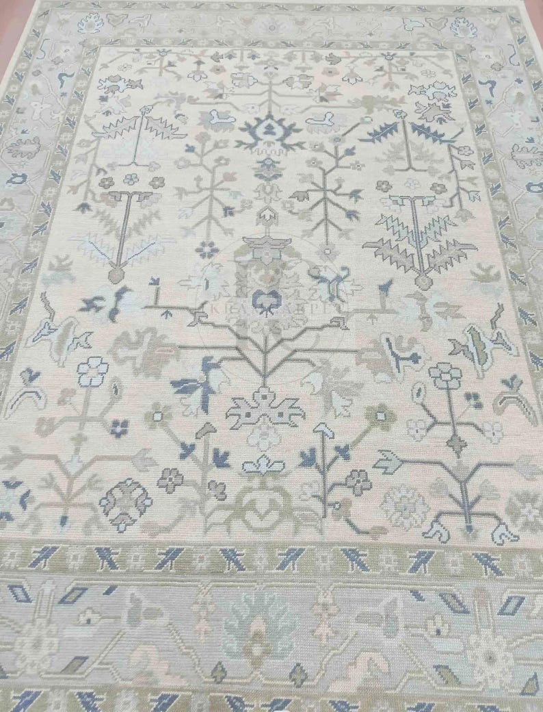 Overhead complete view of the oushak rugs displaying the full symmetry of the sophisticated floral vine borders.