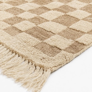 Full overhead shot of an ivory cream and warm beige checkerboard rug, a premium hand-knotted Wollteppich layout for modern homes.