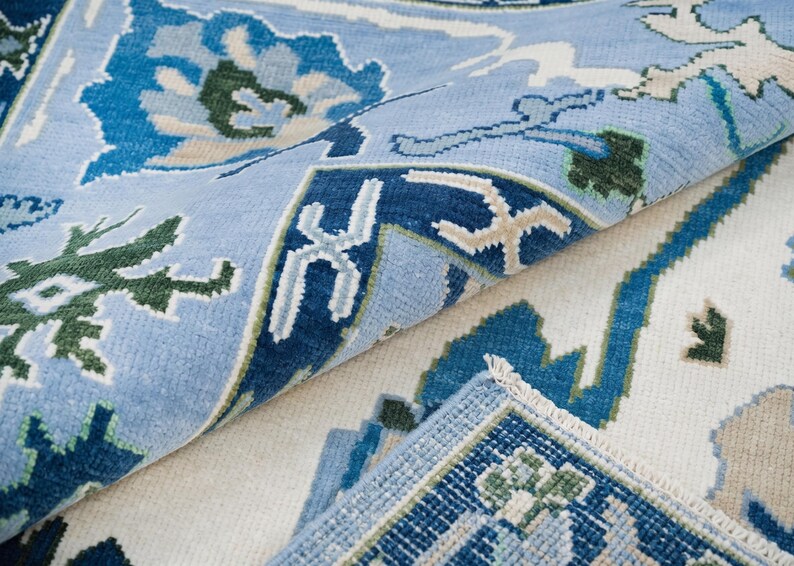 A modern sofa leg resting on the 9x12 area rug, demonstrating the rug's durability and size.