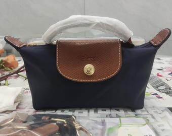 Longchamp Navy Blue mini crossbody bag features an adjustable shoulder strap; compact and portable, it makes the perfect gift for her.