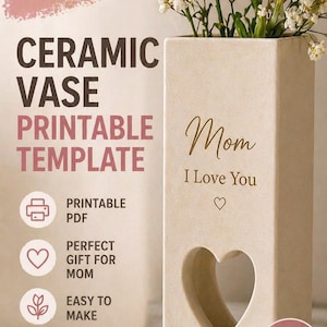 May include: A beige ceramic vase with a heart-shaped cutout, holding pink and white flowers. The vase has the words "Mom I Love You" and "Made with Love." The image also includes text that says "Mother's Day Special" and "Printable Template."
