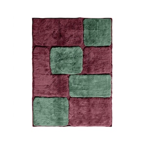 May include: A rectangular area rug featuring a plush, shaggy texture with a block pattern. The design consists of alternating rectangular sections in deep burgundy and muted sage green, creating a geometric arrangement across the entire surface.