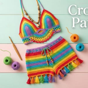 May include: A rainbow-colored crochet bikini top and shorts set with tassel trim. The set is displayed with yarn balls, a crochet hook, and the text "Crochet Pattern PDF". The top has a halter neck and the shorts have a drawstring waist.