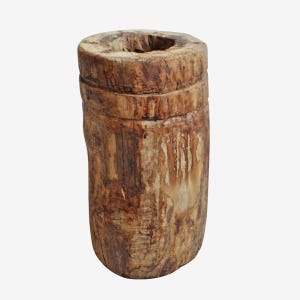 May include: A cylindrical, rustic wooden vase with a hollowed-out top. The vase is made of light brown wood with visible grain and natural imperfections. The design is simple and organic, suitable for displaying dried flowers or branches.