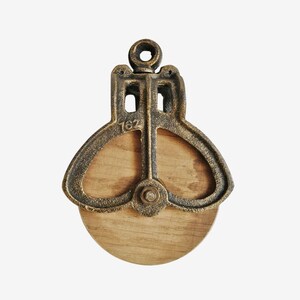 May include: A white ceramic mug with a black handle and the text "But First, Coffee" in a handwritten style. The mug is on a white surface. The mug is approximately 4 inches tall.