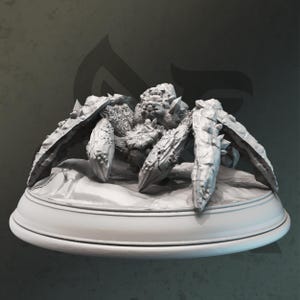 May include: A light gray, unpainted resin miniature of a spider-like creature with a rocky, textured exoskeleton. The figure features multiple pointed legs and a segmented body, mounted on a smooth, circular base with a flat, elevated surface.