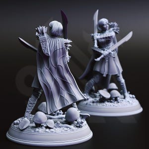 May include: Two gray resin miniature figurines of a warrior character standing on a circular base with mushroom details. The figure wears a cape with a web-like pattern, carries a quiver of arrows on the back, and holds a sword in each hand.