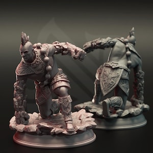 May include: Two grey monochromatic figurines of a kneeling warrior with a mohawk hairstyle, wearing patterned armor and stone-textured gauntlets. The figures are posed in a dynamic stance on a rocky base, showcasing intricate geometric carvings.