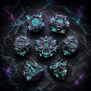 May include: Seven iridescent dice with a floral design, in teal, purple, and green. Each die shows a different number, set against a dark background. These dice are designed for tabletop games.
